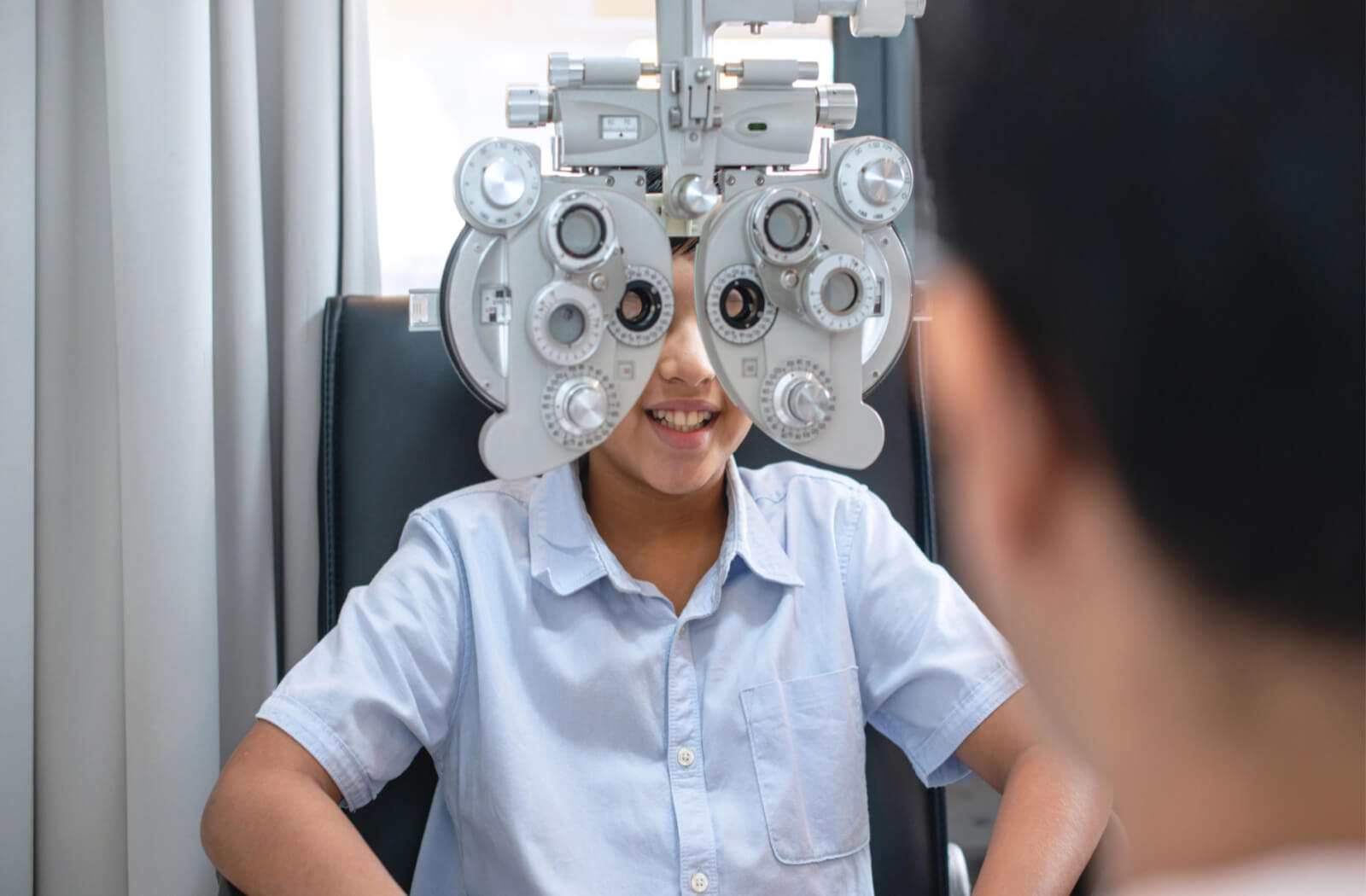 a child has an eye exam done to treat refractive errors