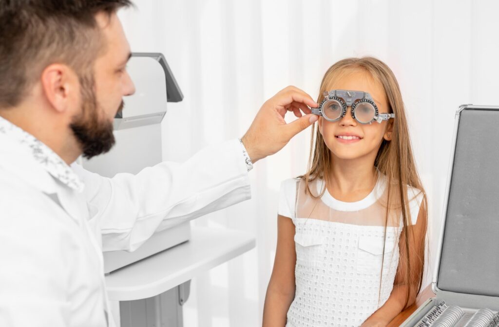 Young girl having eyes examined by optometrist 