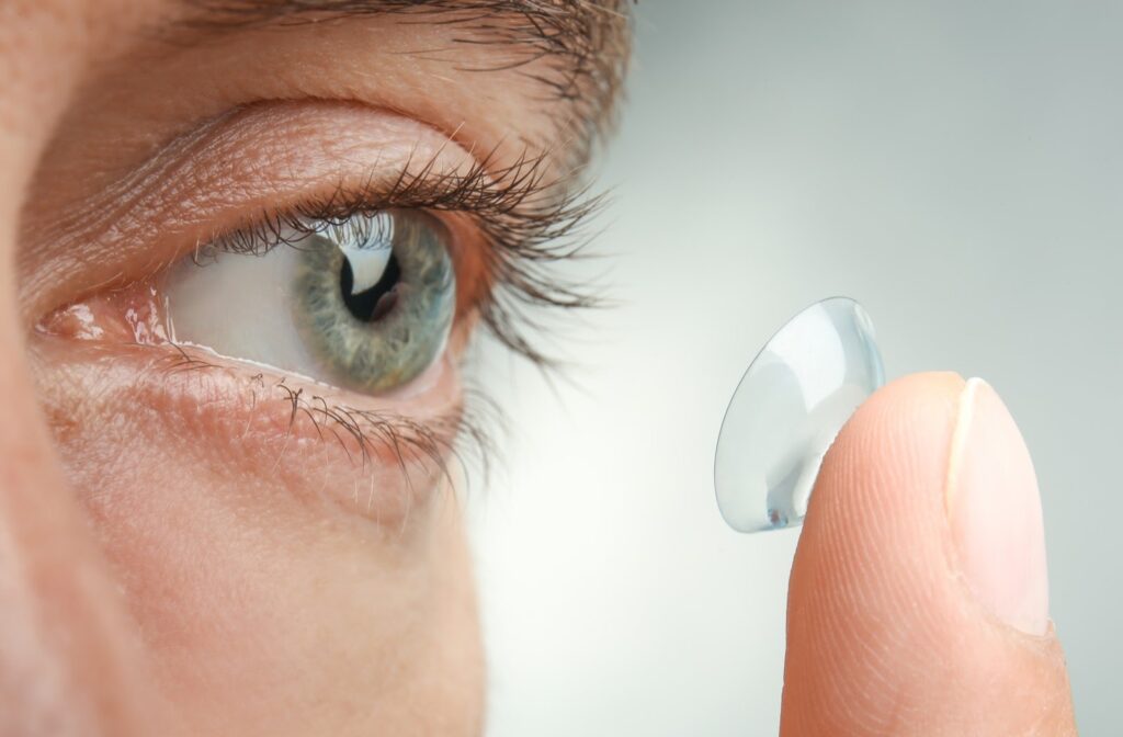Close up of women putting in contact lens into eye
