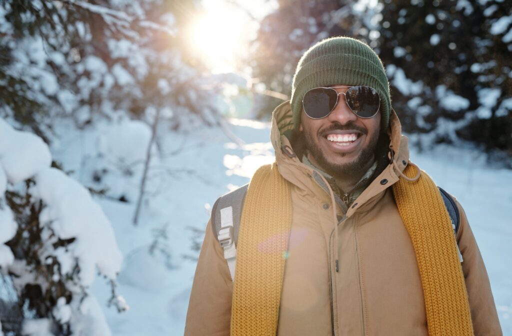 A Calgarian wearing sunglasses to protect their eyes from cold windy weather while on a hike.