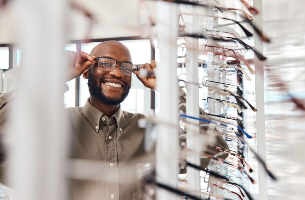 Man trying on wire framed glasses at the optometrist office