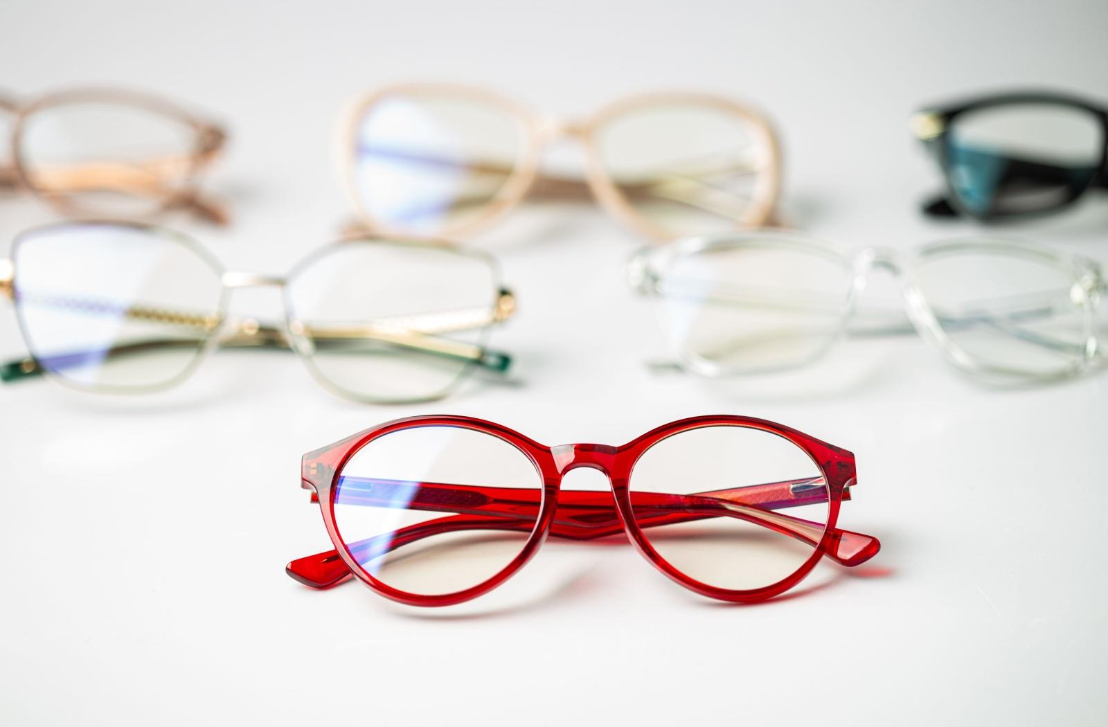 Multiple pairs of unique and colourful glasses.